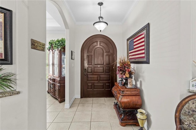 entryway featuring crown molding and light tile patterned floors