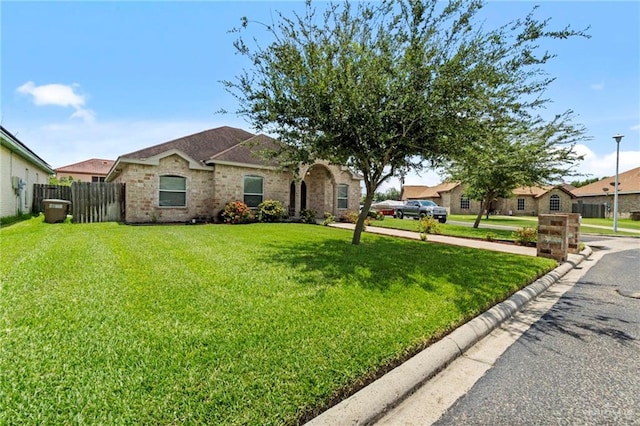 ranch-style home featuring a front yard