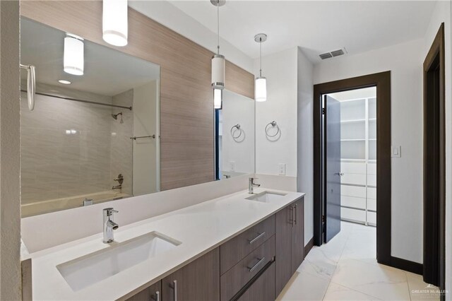 2018 Sabinal St, Mission, TX 78572 - full bathroom with washtub / shower combination, double vanity, and marble finish floors