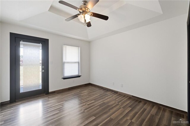 2018 Sabinal St, Mission, TX 78572 - spare room with a tray ceiling, healthy amount of natural light, dark wood-style floors, and a ceiling fan
