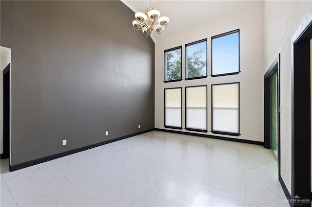 2018 Sabinal St, Mission, TX 78572 - unfurnished room featuring a chandelier, high vaulted ceiling, light marble finish flooring, and baseboards