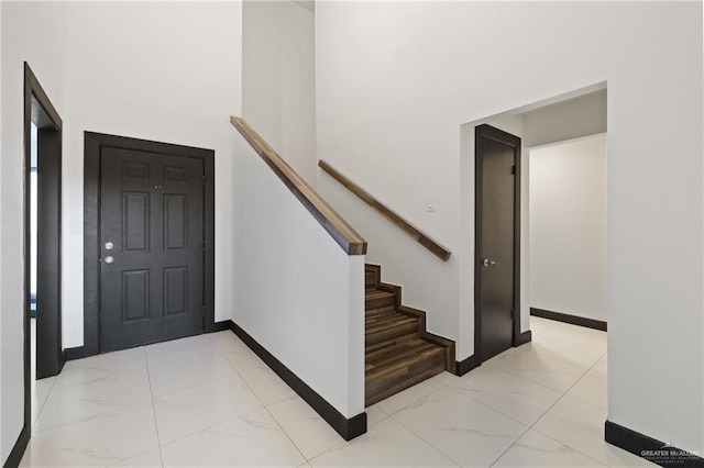 2018 Sabinal St, Mission, TX 78572 - foyer featuring light marble finish floors, baseboards, and a towering ceiling