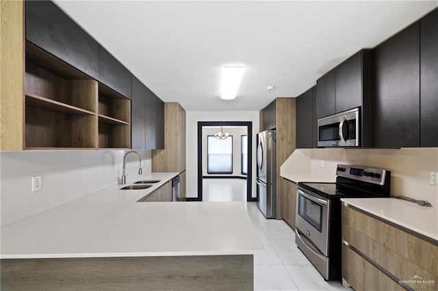 2018 Sabinal St, Mission, TX 78572 - kitchen featuring appliances with stainless steel finishes, a sink, light countertops, modern cabinets, and open shelves