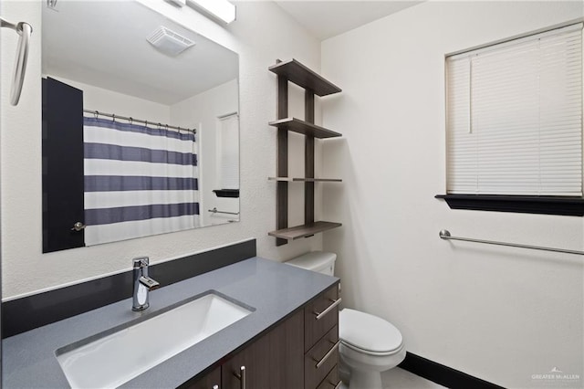 2018 Sabinal St, Mission, TX 78572 - full bath featuring vanity, toilet, and a shower with shower curtain