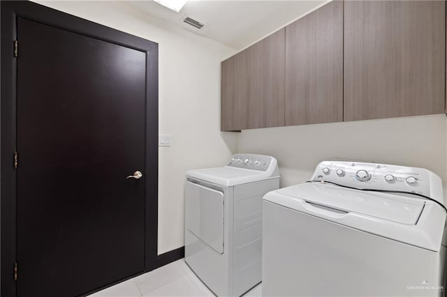 2018 Sabinal St, Mission, TX 78572 - washroom with cabinet space, washing machine and clothes dryer, and light tile patterned flooring