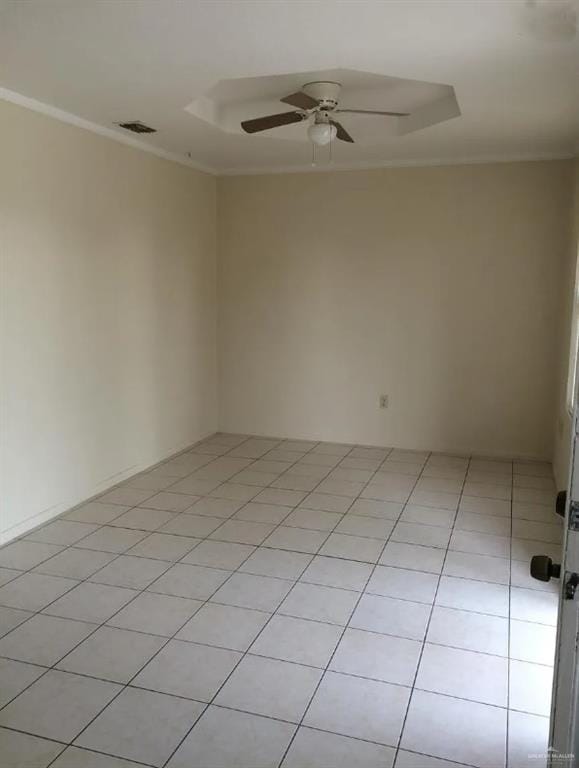 tiled spare room featuring ceiling fan and ornamental molding