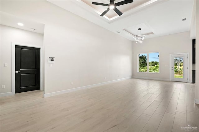 empty room featuring coffered ceiling, light wood-style floors, baseboards, and ceiling fan