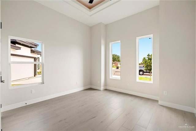 spare room featuring wood finished floors and baseboards