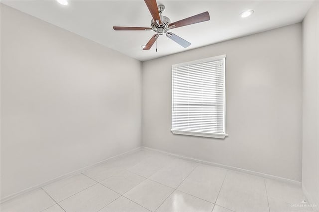 tiled empty room with ceiling fan