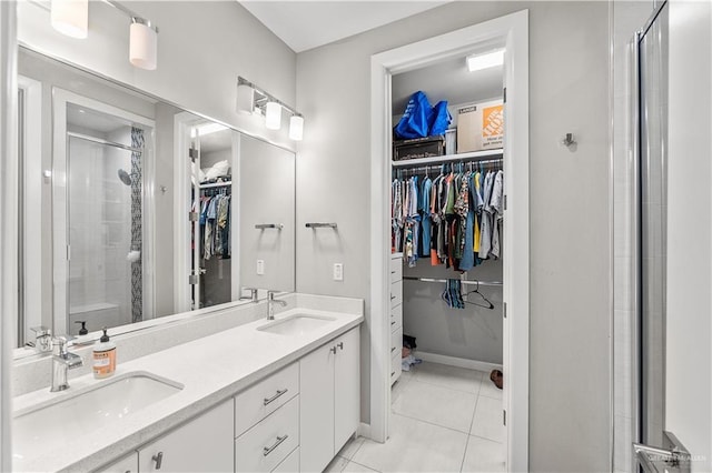 bathroom with tile patterned flooring, vanity, and a shower with shower door