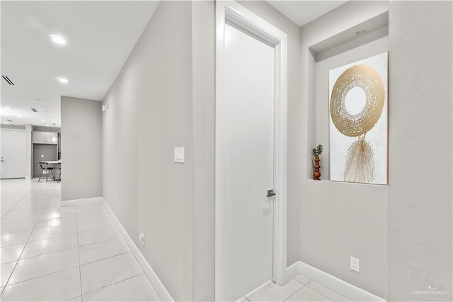 hall with light tile patterned floors