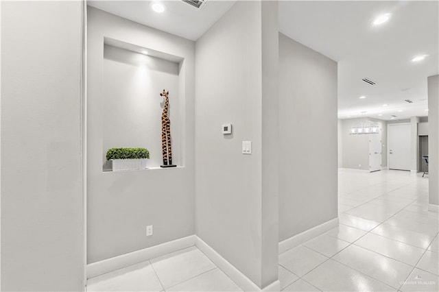 hall featuring light tile patterned floors