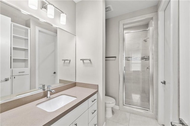 bathroom with toilet, vanity, tile patterned floors, and a shower with door