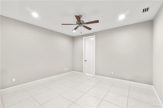 tiled spare room featuring ceiling fan