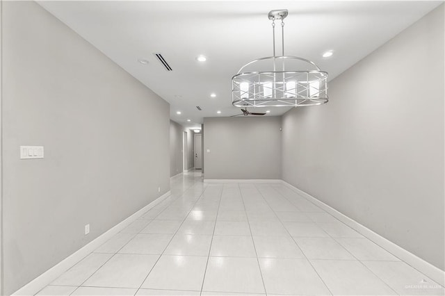 unfurnished dining area featuring light tile patterned flooring and an inviting chandelier