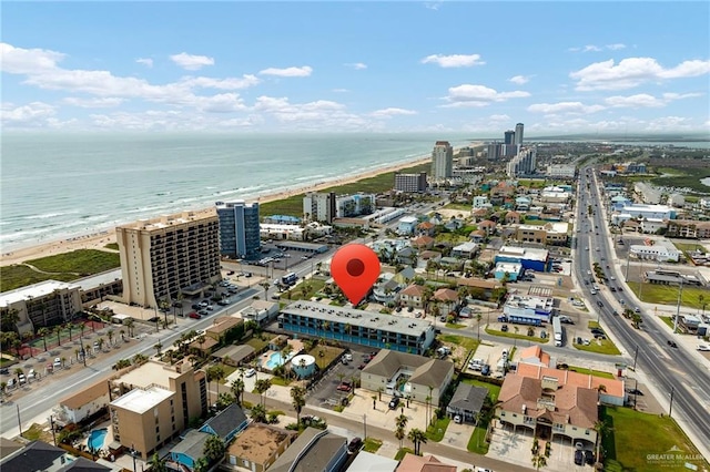 drone / aerial view with a water view and a beach view