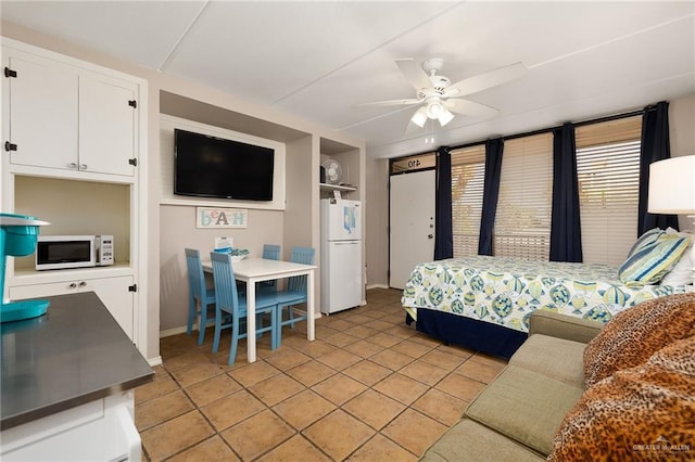 tiled bedroom featuring white fridge and ceiling fan