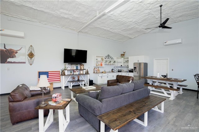 living room featuring a wall mounted AC, ceiling fan, and hardwood / wood-style floors