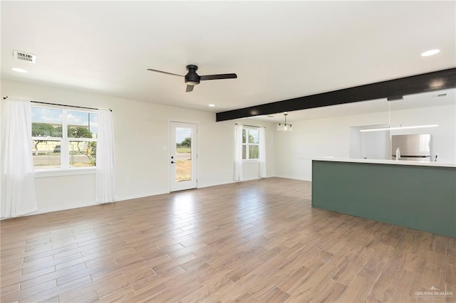 unfurnished living room with beamed ceiling, light wood-type flooring, and ceiling fan