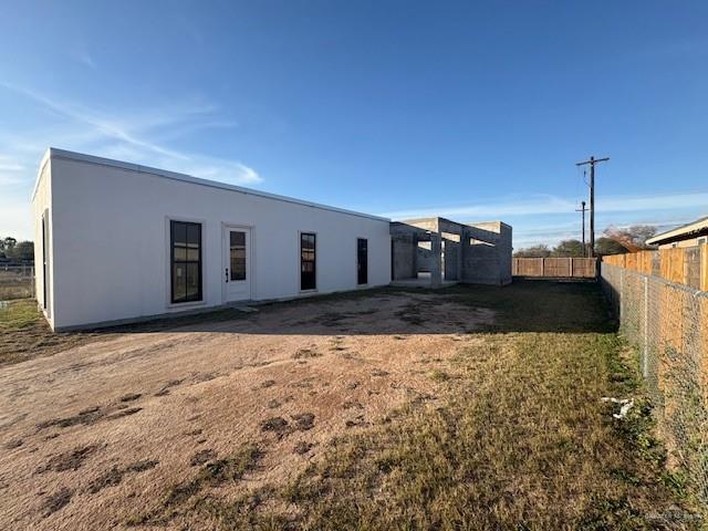 rear view of house featuring a yard