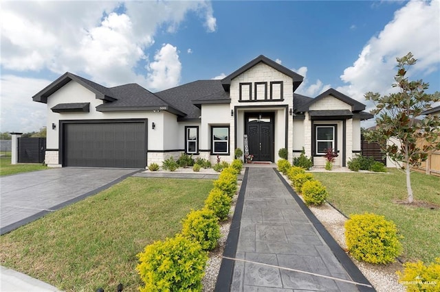 view of front of house featuring a garage and a front lawn