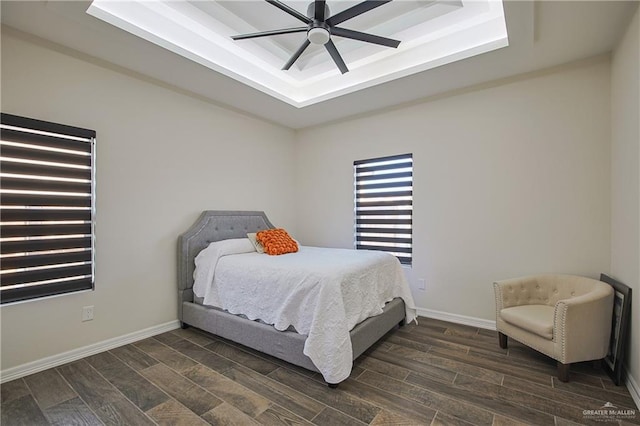 bedroom with a tray ceiling and ceiling fan