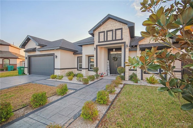 view of front of property featuring a garage and a front lawn