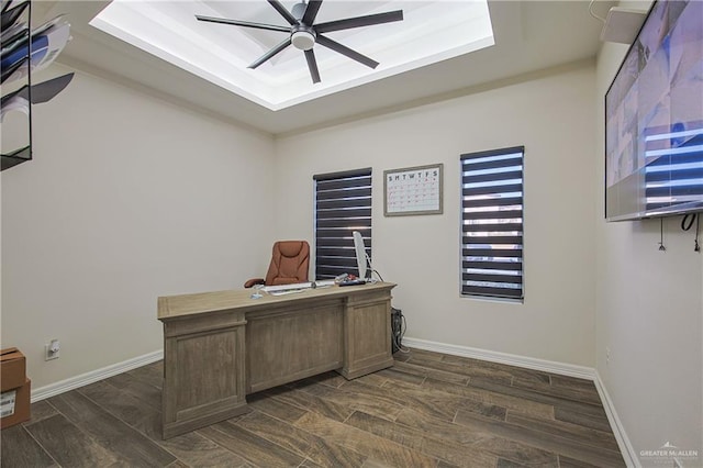 office featuring a raised ceiling and ceiling fan