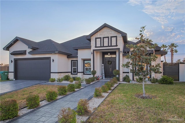 view of front of property with a garage and a front lawn