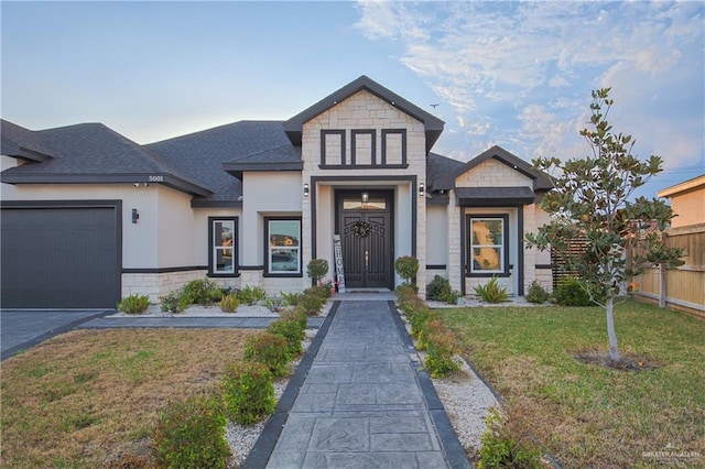 view of front of property with a garage and a front lawn