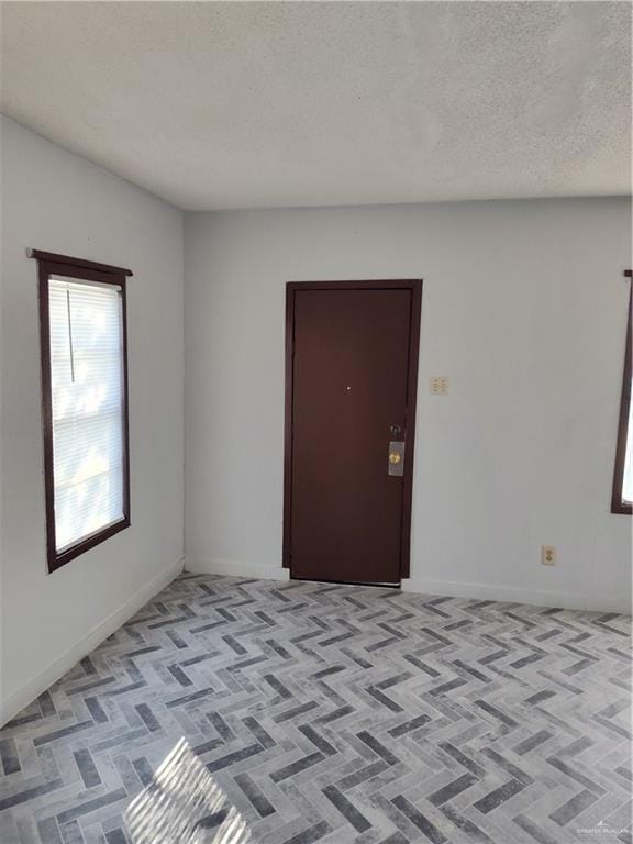 empty room featuring a textured ceiling