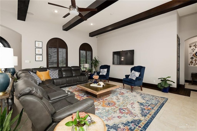 tiled living room featuring beamed ceiling and ceiling fan