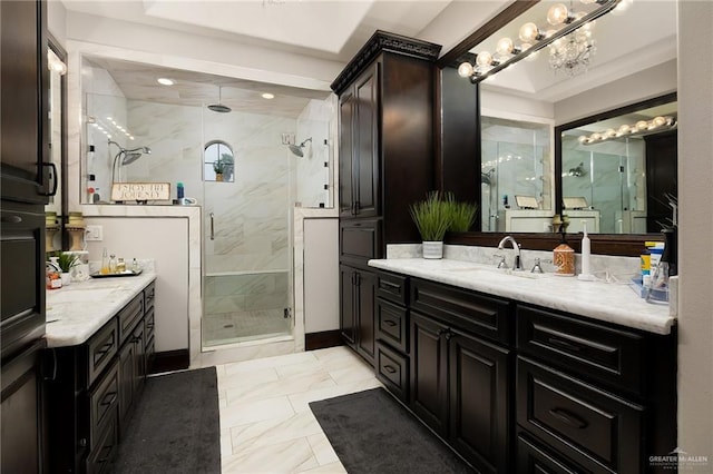 bathroom featuring vanity, a notable chandelier, and walk in shower