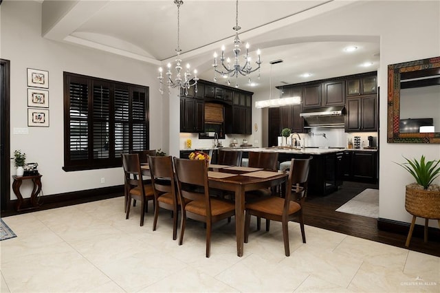 dining area featuring light hardwood / wood-style floors and an inviting chandelier