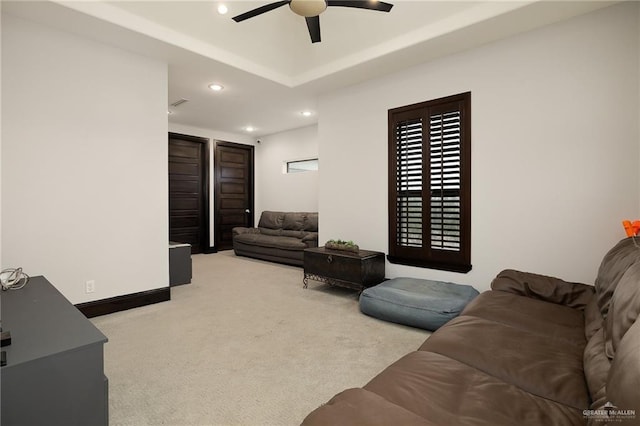 carpeted living room with ceiling fan