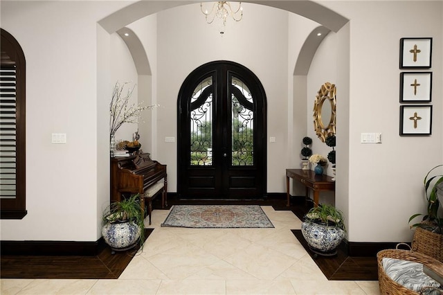 foyer featuring a notable chandelier and french doors