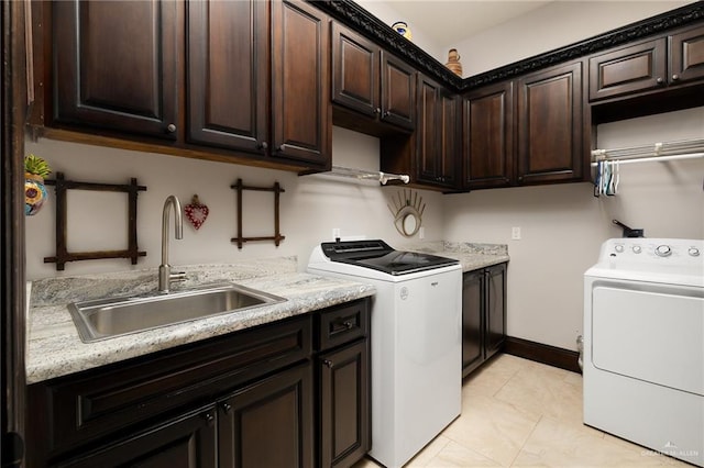 washroom featuring cabinets, independent washer and dryer, and sink