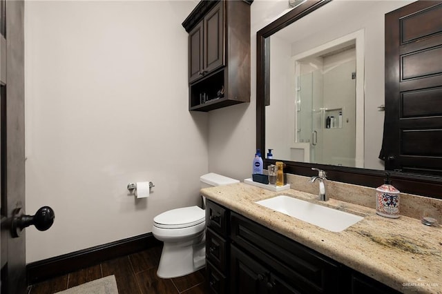 bathroom with hardwood / wood-style flooring, vanity, and toilet