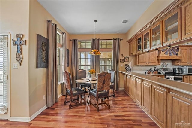 dining area featuring light wood-type flooring and sink