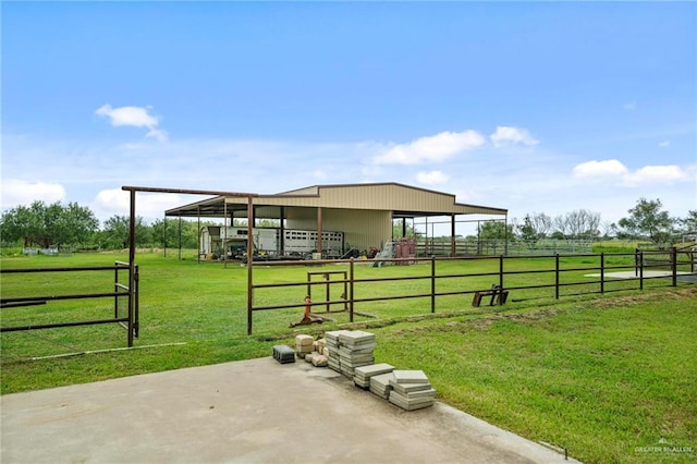 view of yard featuring an outbuilding and a rural view