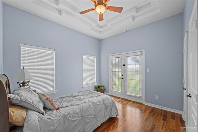 bedroom with access to exterior, french doors, a raised ceiling, ceiling fan, and dark hardwood / wood-style floors