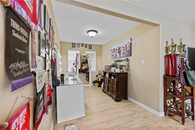 hallway with light hardwood / wood-style floors