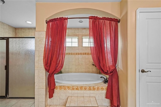 bathroom with tile patterned floors and plus walk in shower