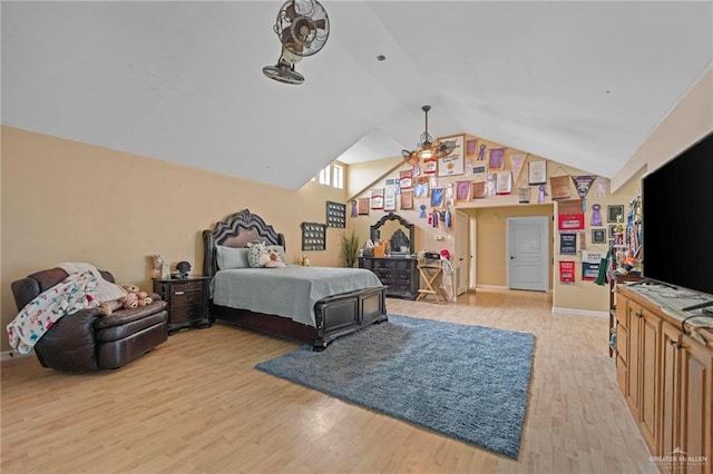 bedroom featuring light hardwood / wood-style floors and vaulted ceiling