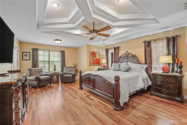 bedroom with ceiling fan, light hardwood / wood-style flooring, and coffered ceiling