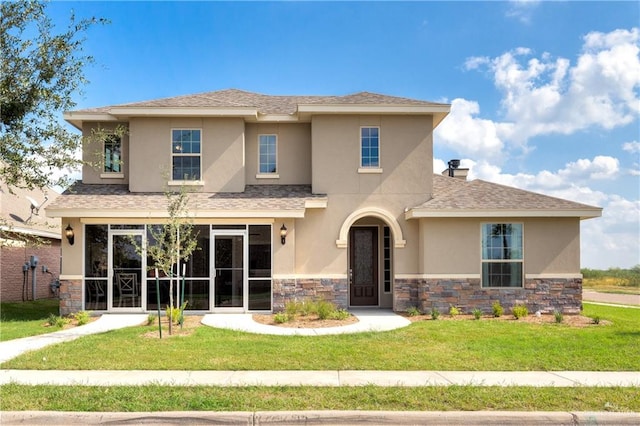 view of front of home featuring a sunroom and a front yard