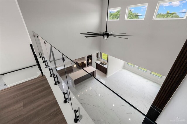 1013 N Buxton Ave, Edinburg, TX 78541 - stairs featuring ceiling fan, wood finished floors, and baseboards