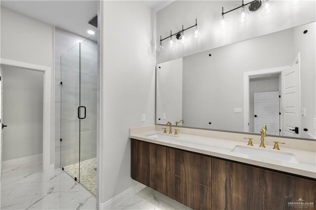 1013 N Buxton Ave, Edinburg, TX 78541 - bathroom with marble finish floors, a shower stall, baseboards, and double vanity