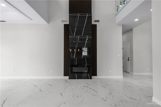 1013 N Buxton Ave, Edinburg, TX 78541 - unfurnished living room featuring marble tiled floors, baseboards, and recessed lighting