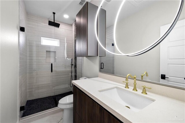 1013 N Buxton Ave, Edinburg, TX 78541 - full bath with marble look tiles, toilet, a shower stall, vanity, and recessed lighting